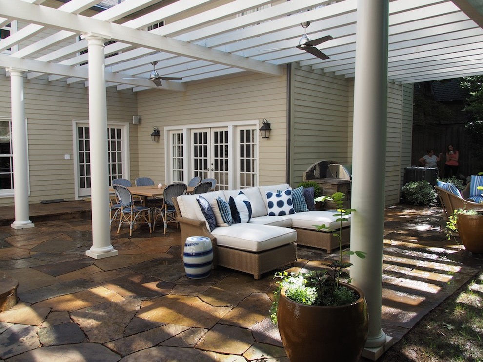 Photo of a medium sized classic back patio in Dallas with natural stone paving and a pergola.