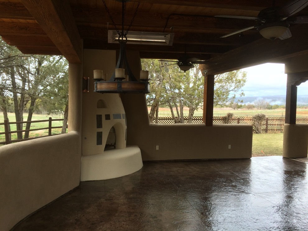 Inspiration for a large back patio in Denver with an outdoor kitchen, stamped concrete and a roof extension.