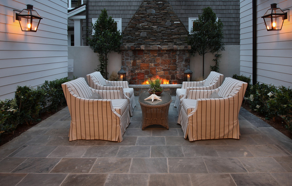 Elegant patio photo in Orange County with a fire pit