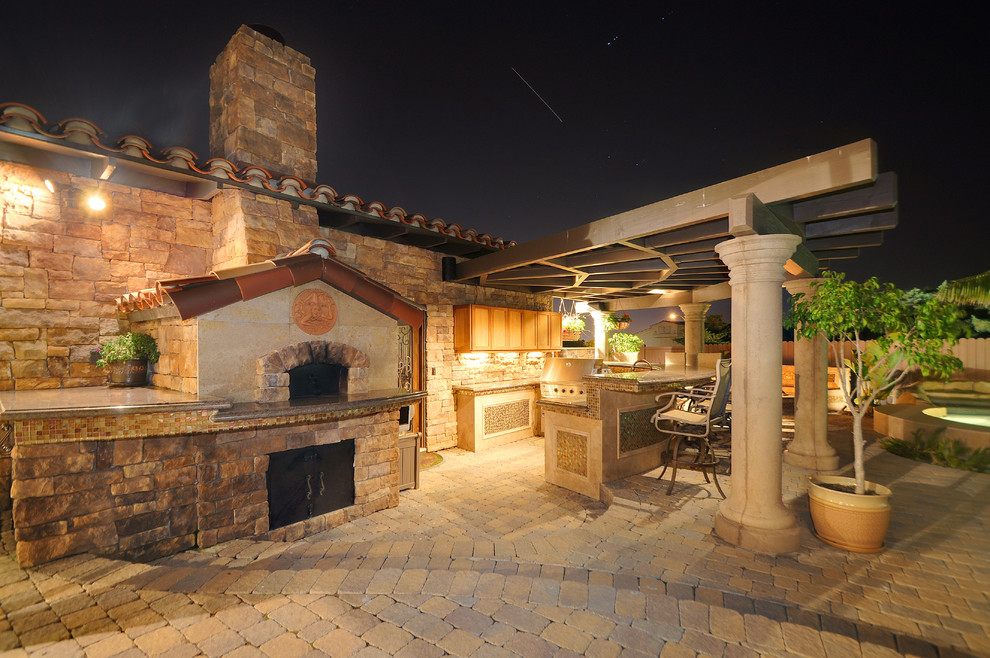 This is an example of a mediterranean patio in San Diego with a pergola and a bar area.