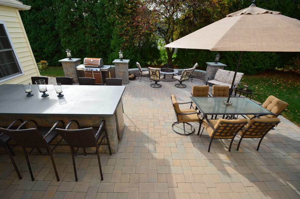 Inspiration for a medium sized classic back patio in Philadelphia with a fire feature, natural stone paving and no cover.