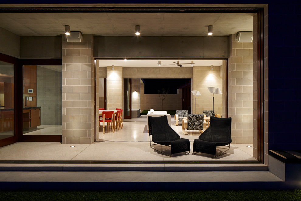 Example of a trendy backyard patio design in Sydney with a roof extension