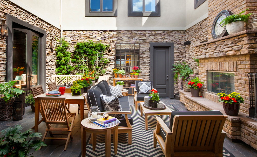Inspiration for a large coastal courtyard stone patio remodel in San Diego with no cover