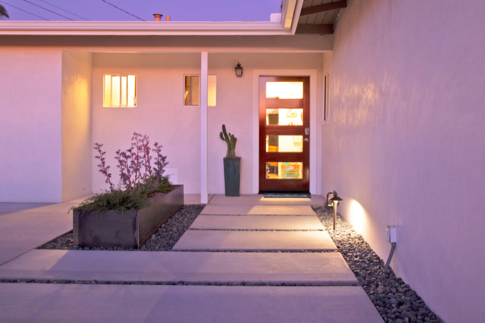 Medium sized modern front patio in San Luis Obispo with concrete slabs.