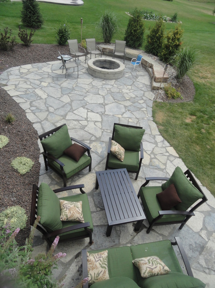Photo of a medium sized rustic side patio in Detroit with a potted garden and natural stone paving.