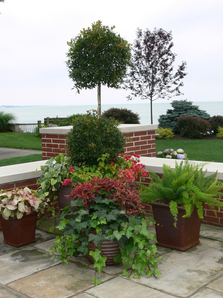 Large elegant backyard stone patio container garden photo in Cleveland
