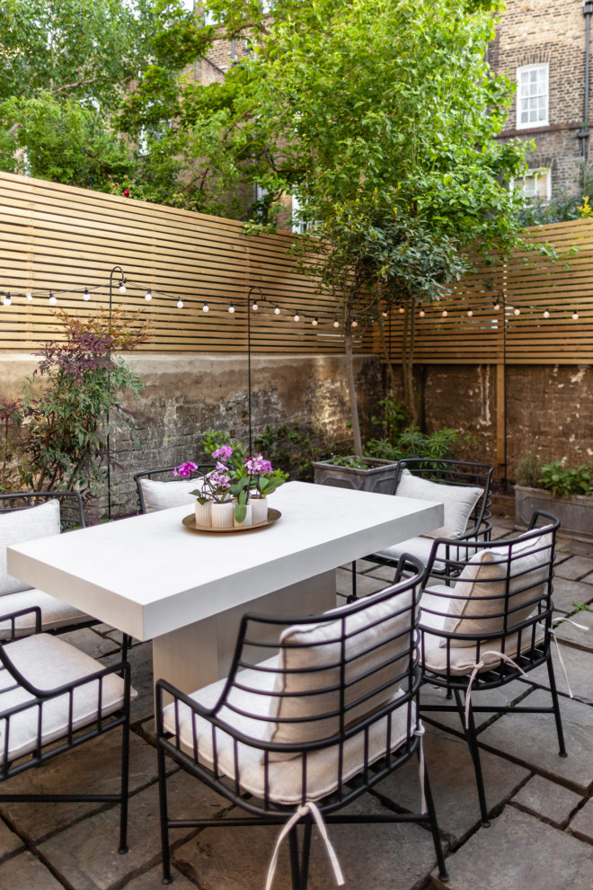 Example of a transitional patio design in London