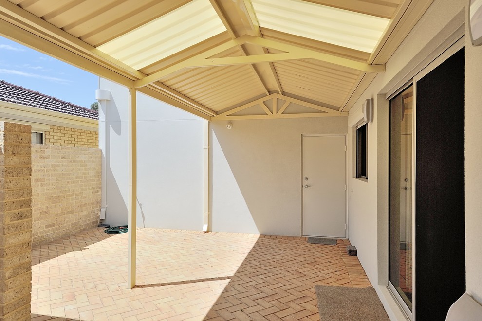 Example of a mid-sized eclectic side yard brick patio design in Perth with a gazebo