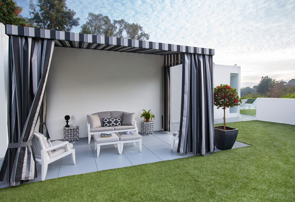 Mid-century modern side yard concrete patio photo in Los Angeles with a gazebo