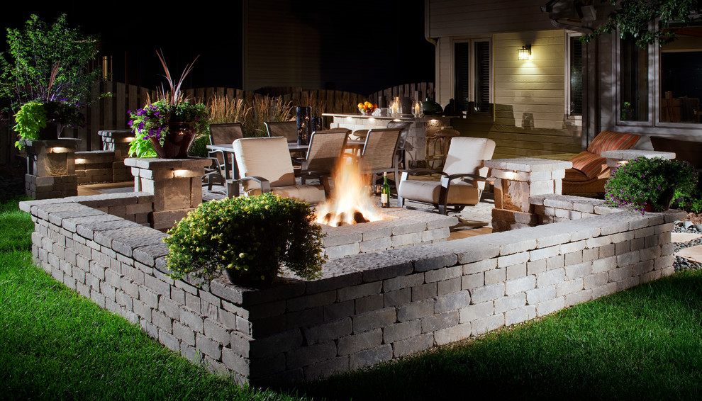Design ideas for a medium sized classic back patio in Dallas with a fire feature, natural stone paving and no cover.