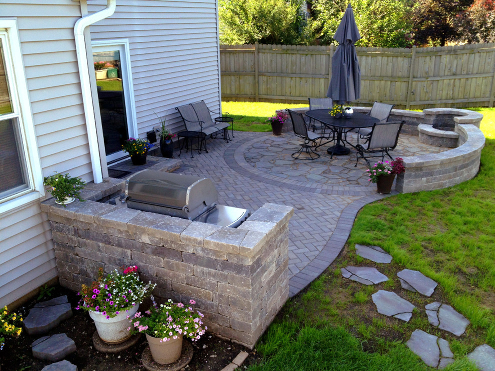 Patio - mid-sized traditional backyard brick patio idea in Chicago with a fire pit and no cover