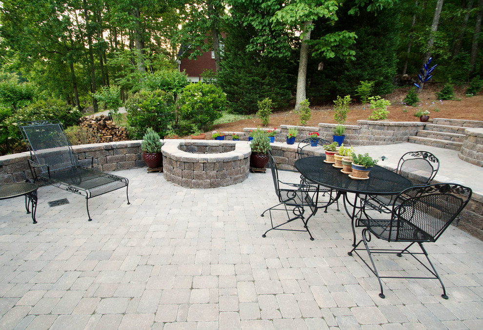 Mid-sized elegant backyard brick patio photo in Atlanta with a fire pit and no cover