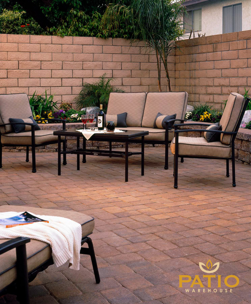 Inspiration for a rustic backyard concrete paver patio remodel in Orange County