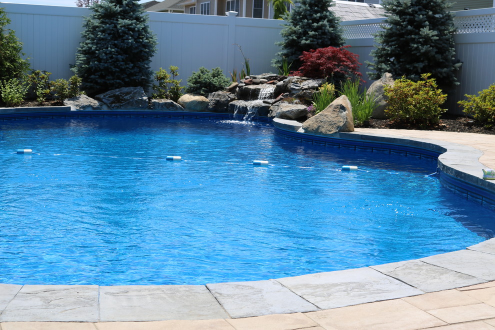 Pool fountain - traditional backyard pool fountain idea in New York