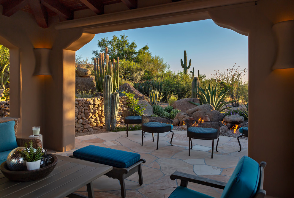 Inspiration for a large back patio in Phoenix with a fire feature, tiled flooring and a roof extension.