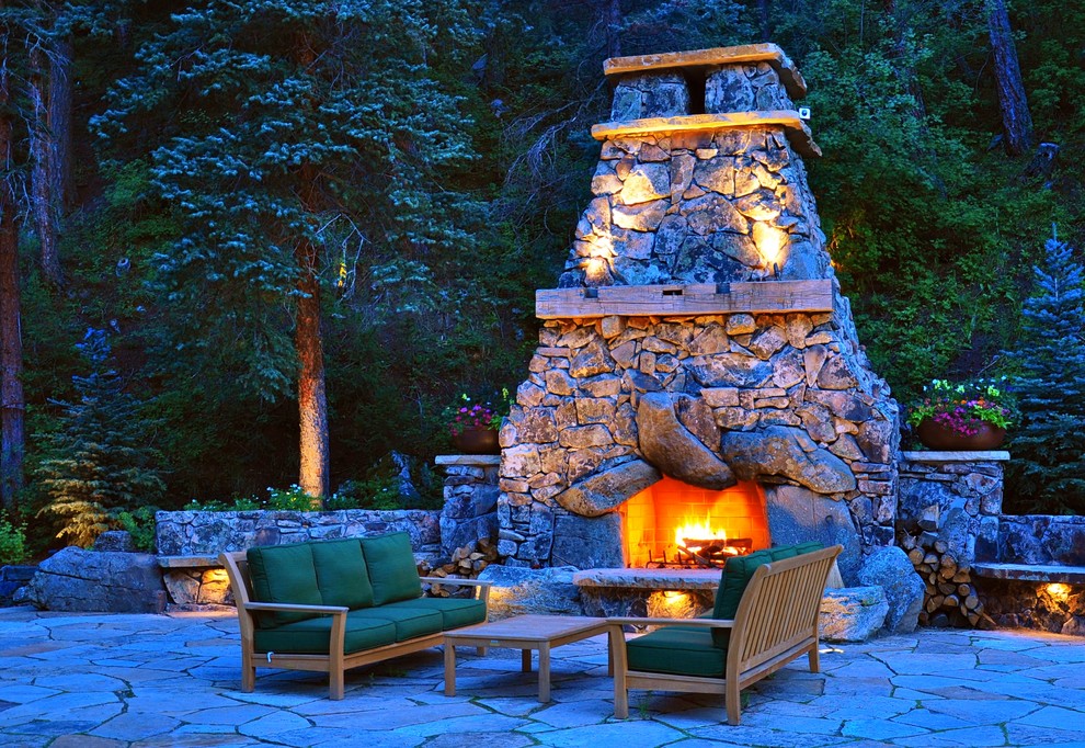 This is an example of a traditional patio in Denver with a fire feature.