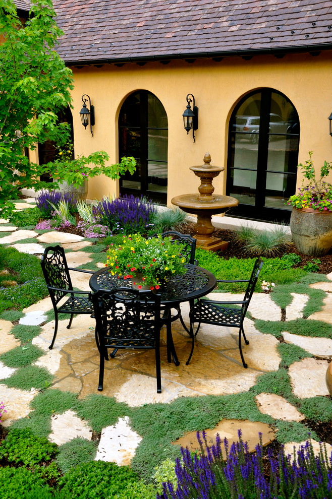 Example of a tuscan courtyard patio design in Denver