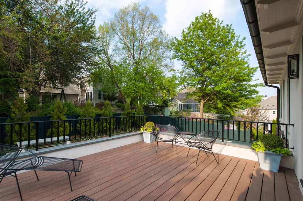 This is an example of a medium sized contemporary back patio in DC Metro with decking and no cover.