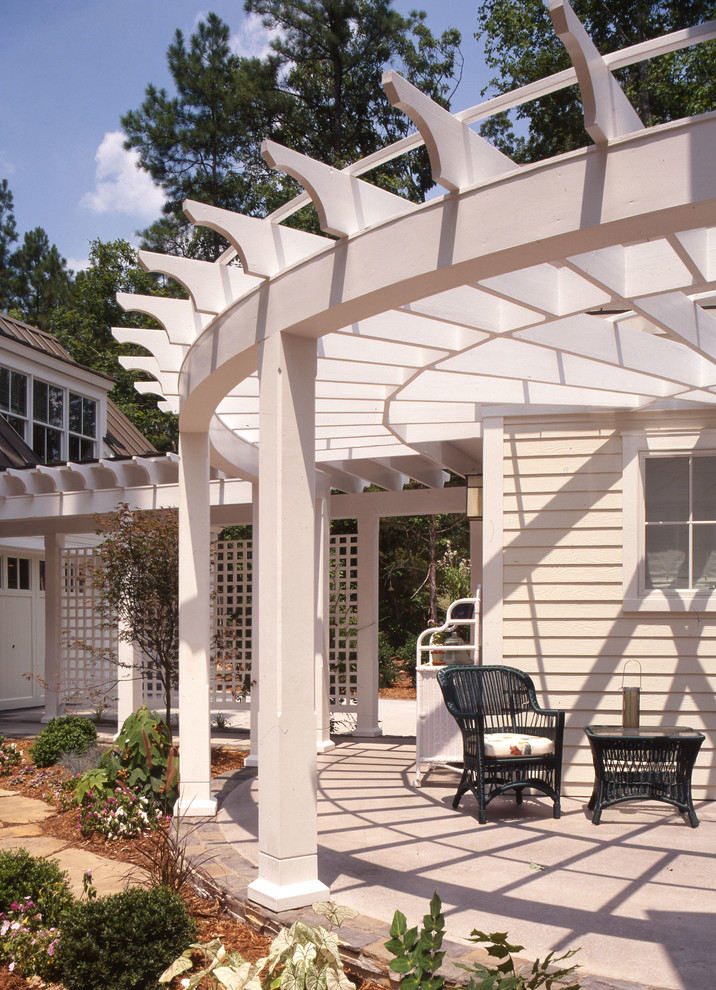 Inspiration for a mid-sized transitional backyard concrete patio remodel in Raleigh with a pergola