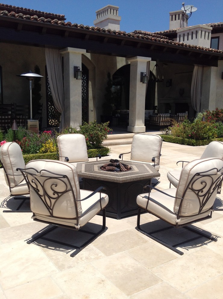 Design ideas for a mediterranean patio in Los Angeles with a fire feature and no cover.