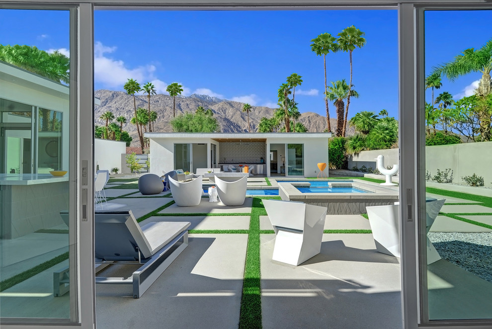 Immagine di un patio o portico minimalista di medie dimensioni e dietro casa con pavimentazioni in cemento e nessuna copertura