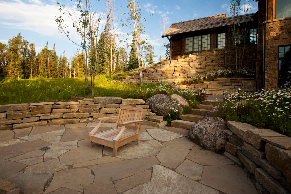 Design ideas for a rustic patio in Other with natural stone paving and no cover.