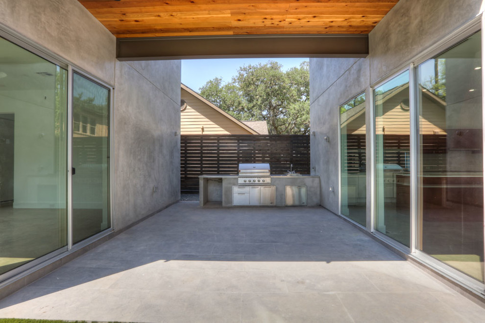 Inspiration for a medium sized modern back patio in Houston with an outdoor kitchen, concrete paving and no cover.