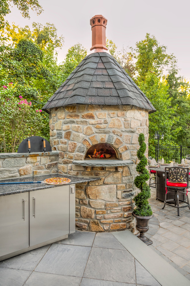 Inspiration for an expansive rustic back patio in Philadelphia with an outdoor kitchen and natural stone paving.