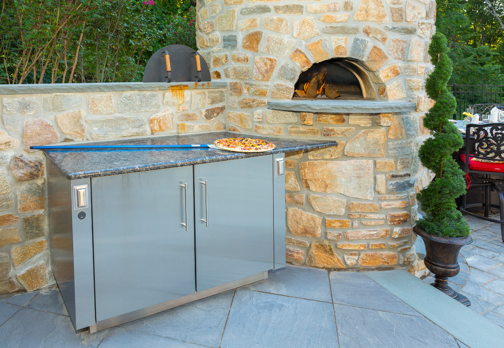 Photo of a large rustic back patio in Philadelphia with an outdoor kitchen.