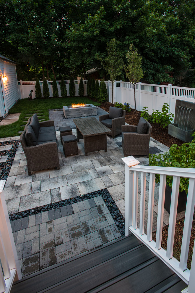 Photo of a medium sized contemporary back patio in Detroit with a fire feature, brick paving and no cover.