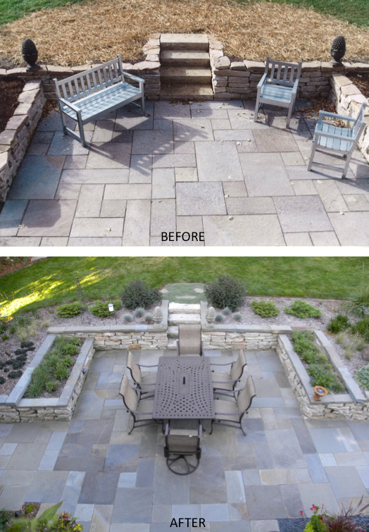 This is an example of an expansive classic back patio in Milwaukee with natural stone paving.