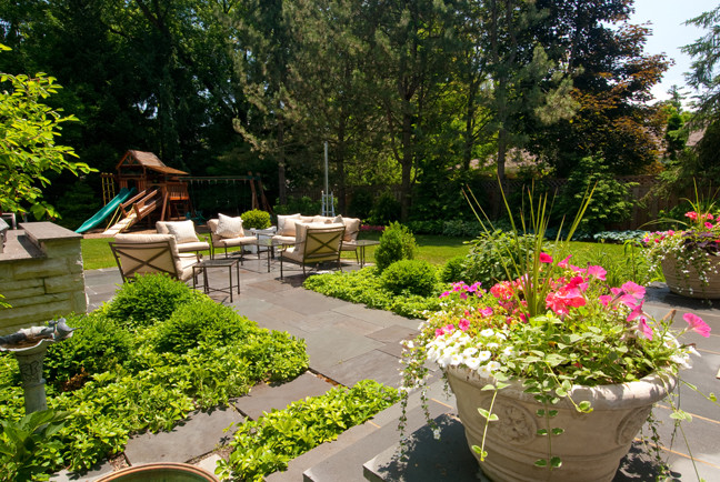 Inspiration for a large timeless backyard stone patio remodel in Chicago