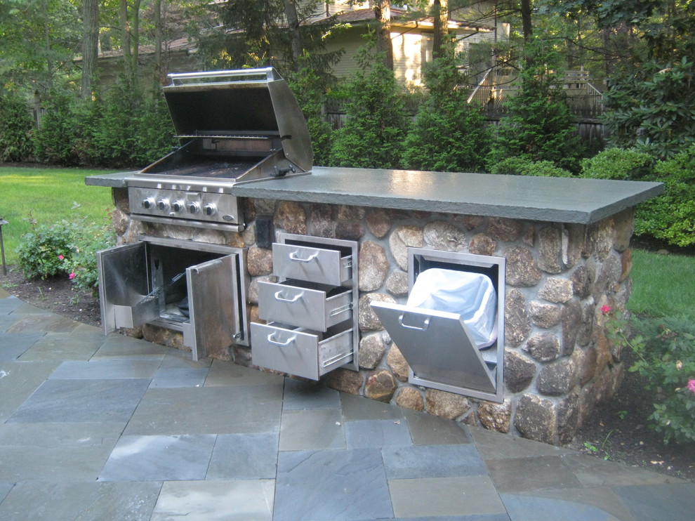 Inspiration for a large traditional back patio in New York with an outdoor kitchen and tiled flooring.