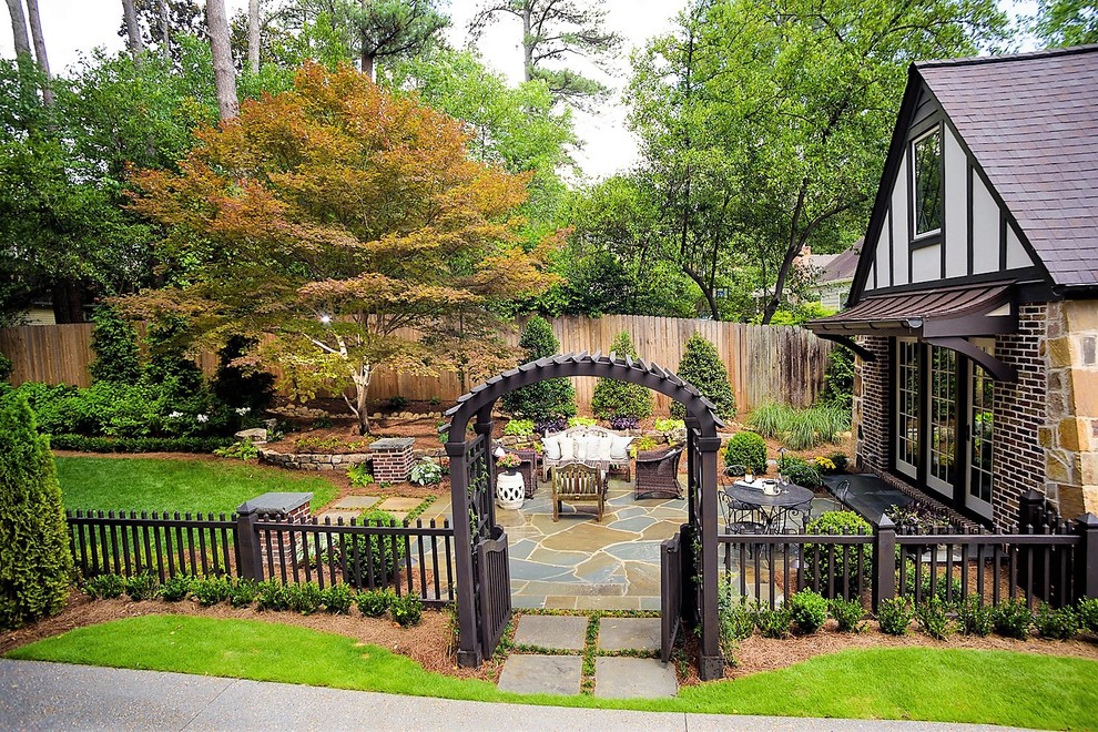 Mid-sized backyard stone patio photo in Atlanta