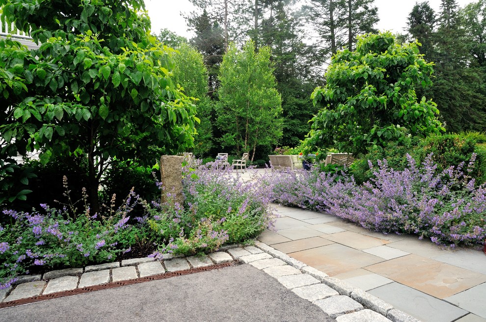 This is an example of a large traditional partial sun backyard stone landscaping in Boston with a fire pit for summer.