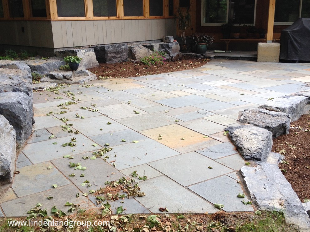 blustone patio with Panton boulder edge Traditional Patio