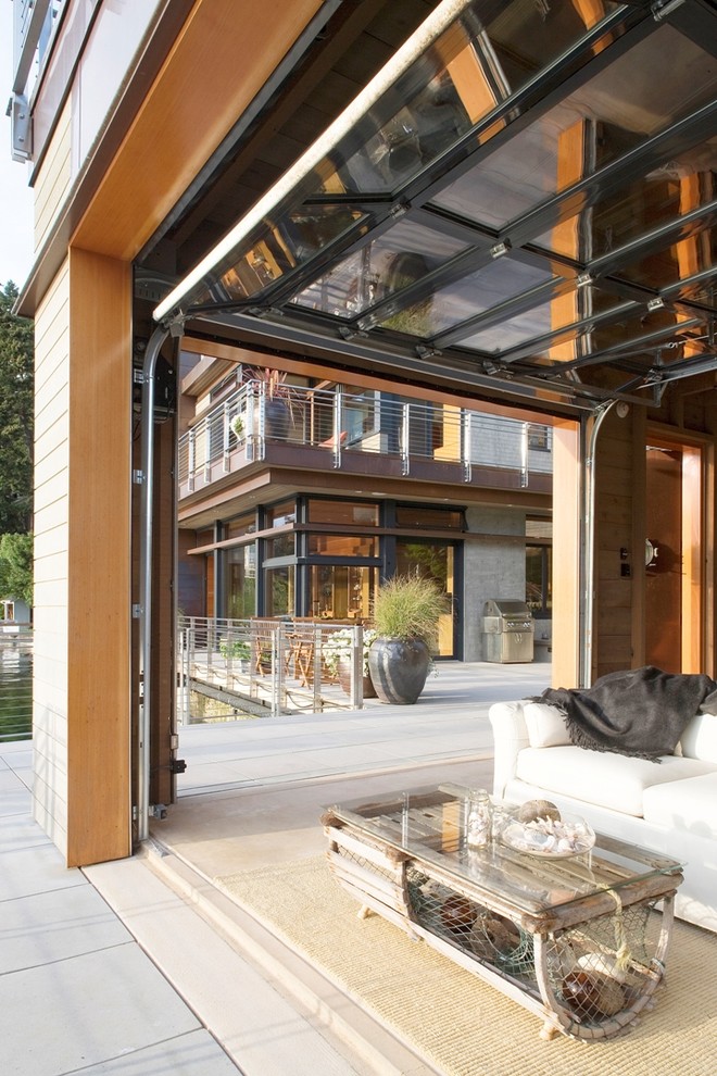 Inspiration for a contemporary patio in Seattle with a roof extension.