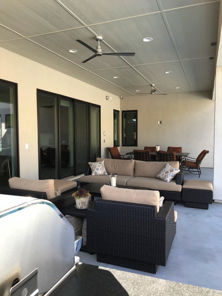 Photo of a modern back patio in Boise with concrete slabs.