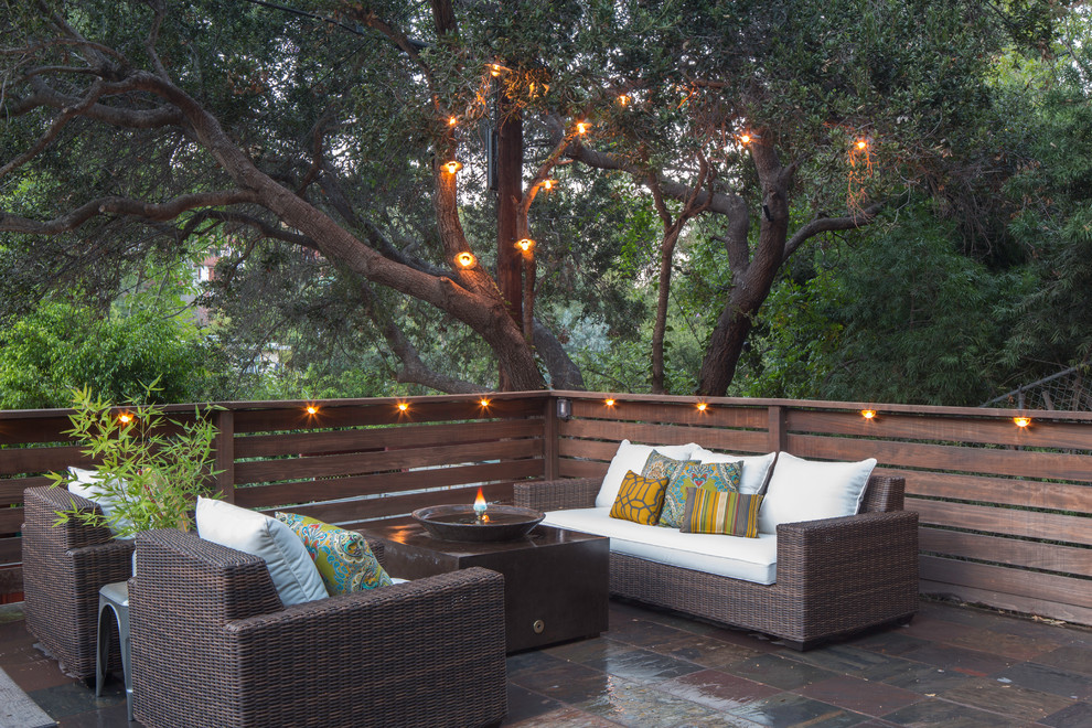 Bohemian patio in Los Angeles with a fire feature, tiled flooring and no cover.