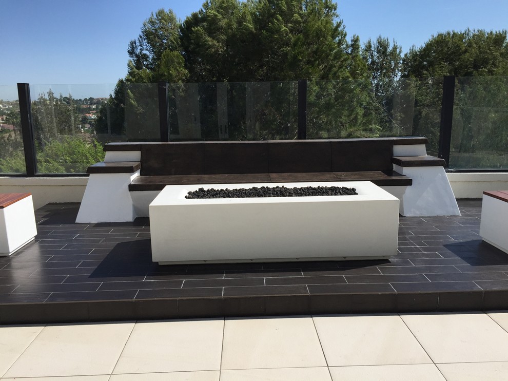Example of a mid-sized trendy backyard tile patio design in San Diego with a fire pit and no cover