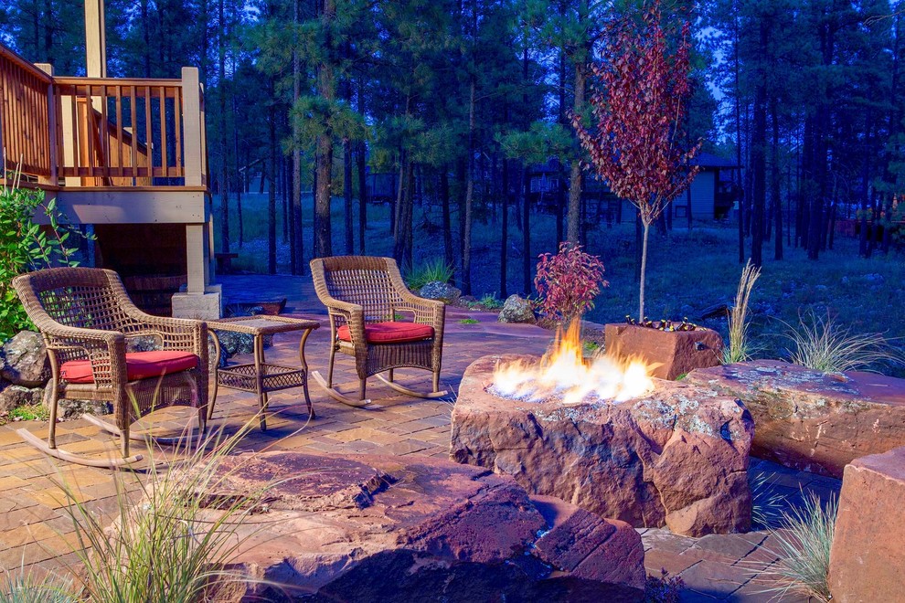 Design ideas for a medium sized rustic back patio in Denver with a fire feature, brick paving and no cover.