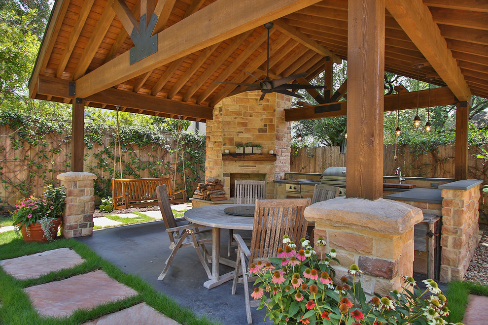 Design ideas for a large rustic back patio in Houston with an outdoor kitchen, concrete paving and a gazebo.