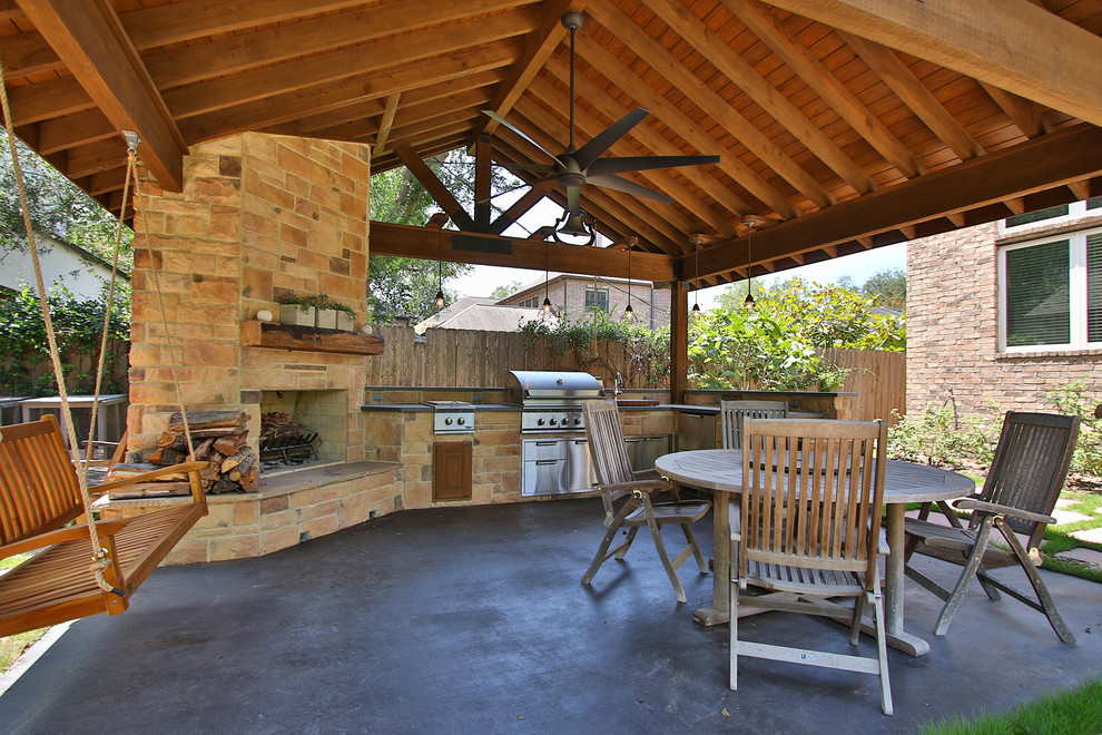 Large mountain style backyard concrete paver patio kitchen photo in Houston with a gazebo