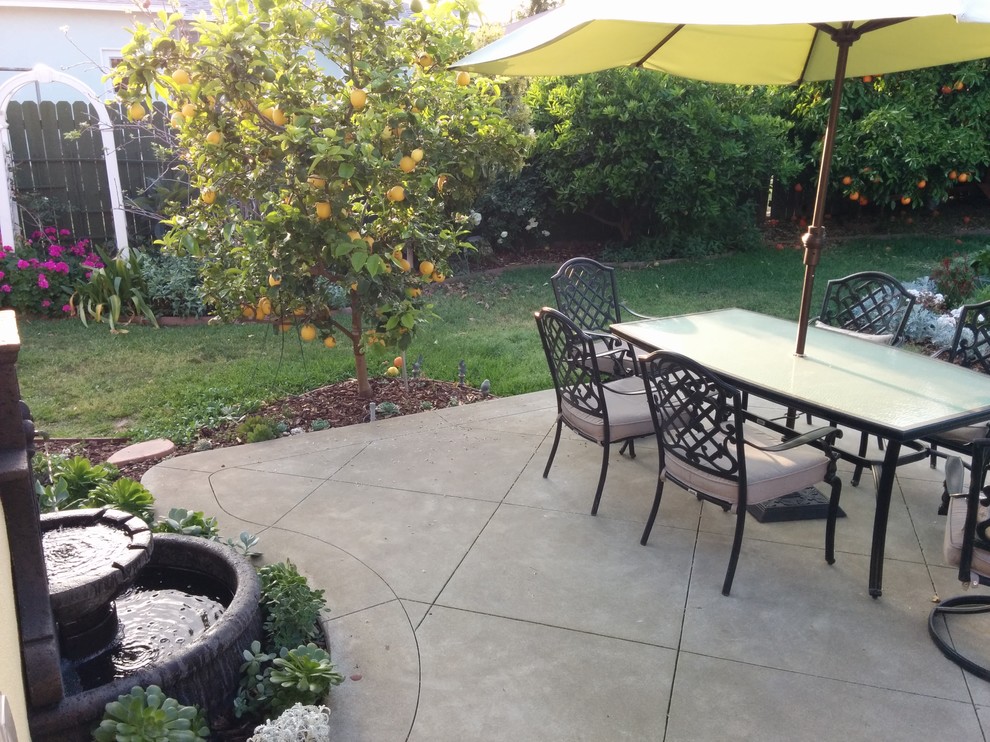 Inspiration for a medium sized classic back patio in Orange County with concrete slabs and no cover.