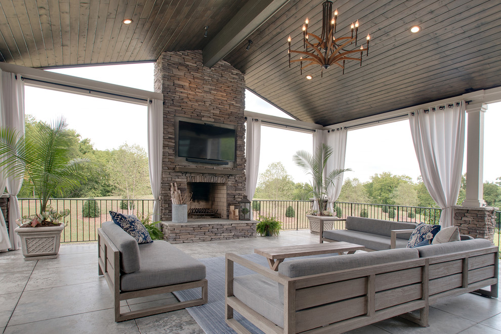 Inspiration pour une grande terrasse arrière vintage avec une cuisine d'été, une dalle de béton et une extension de toiture.