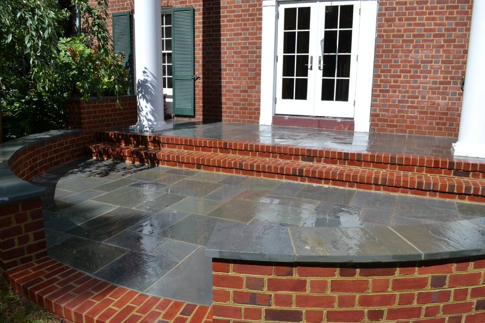 Example of a mid-sized classic backyard brick patio design in DC Metro