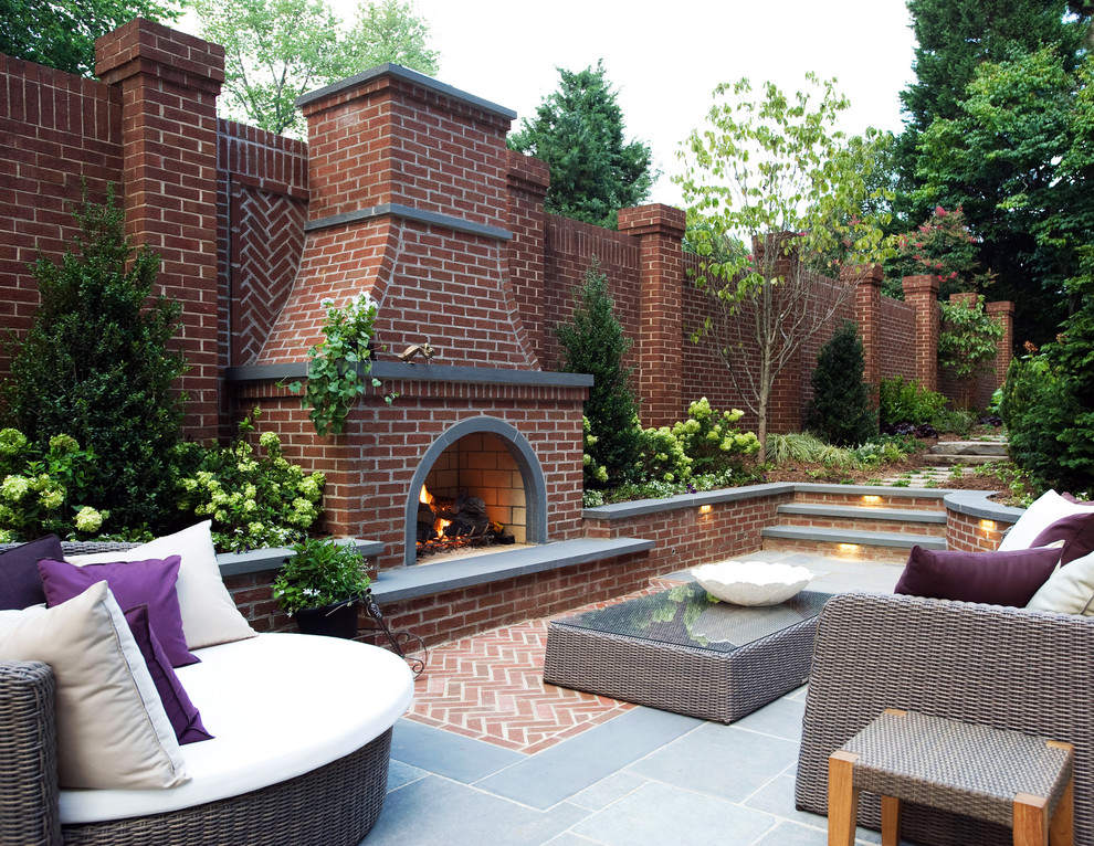 Design ideas for a traditional patio in DC Metro with a fire feature and natural stone paving.