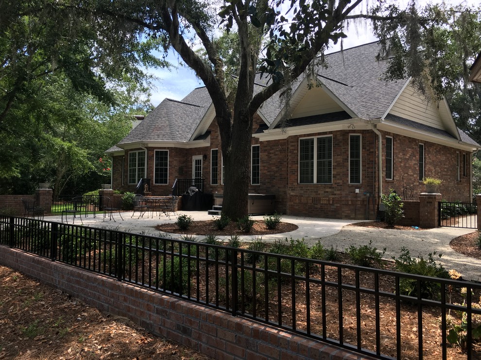 Brick knee wall with aluminum pickets Traditional Patio