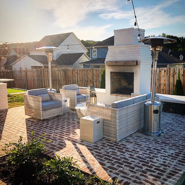 Patio - large shabby-chic style backyard brick patio idea in Birmingham with a fireplace