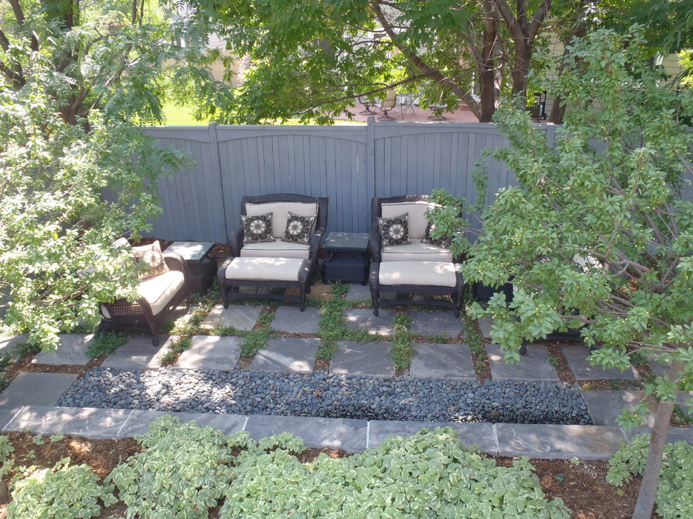 Mid-sized minimalist backyard brick patio photo in Denver with a pergola